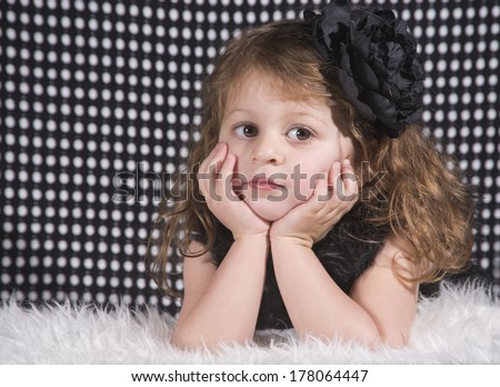 Little Girl in black with a hair bow
