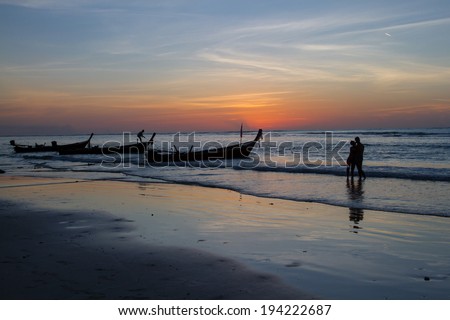 The silhouette picture of couple on the beach.