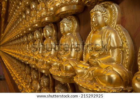 The interior decoration by small Buddha sculptures in Chinese temple.