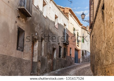 Curved steep street in old Toledo, Spain.