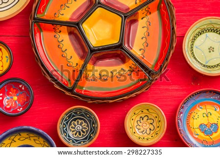 GRONINGEN, HOLLAND - APRIL 25: Set of typical empty tapas dishes on a red wooden table on April 25, 2015 in Groningen