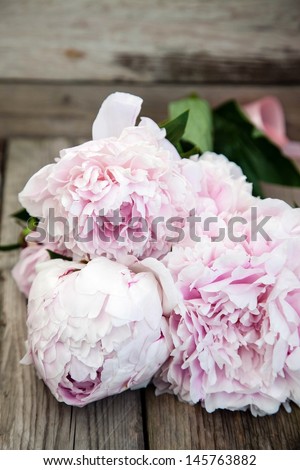 bouquet of peonies on a wooden background
