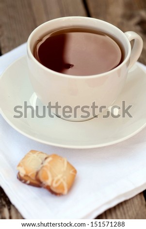 Cup of freshly brewed earl grey tea with petit four