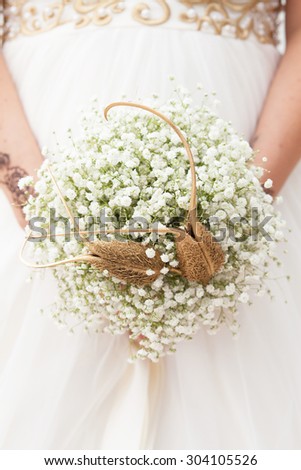 Bride holding little beautiful wedding bouquet. Modern wedding bouquet. Bride for wedding.