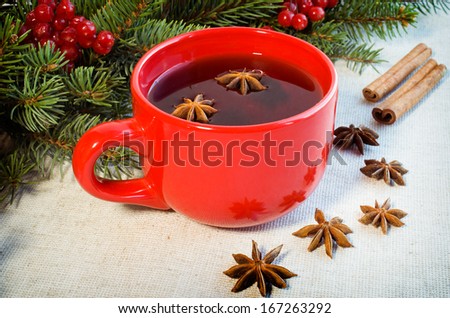 warm mulled wine poured in a red ceramic mug