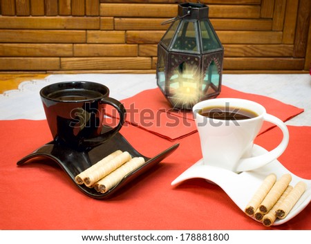 two cups of coffee and wafer sticks with chocolate