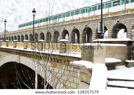 Grey winter day with snow laying everywhere, parisian metro train crossing the bridge over the Seine River. This picture makes me think about Hogwarts Express. / Paris metro train on the bridge