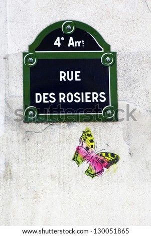 Rue des rosiers / Street name sign in paris with the butterfly drawing beneath. Rue des Rosiers is one of the well known streets in the jewish and gay Marais district in Paris, France