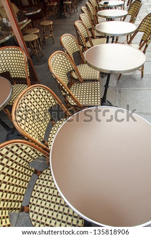 Traditional parisian coffee house / Paris - traditional french cafe with it\'s round tables and chairs outdoors on the sidewalk, wide-angle lens