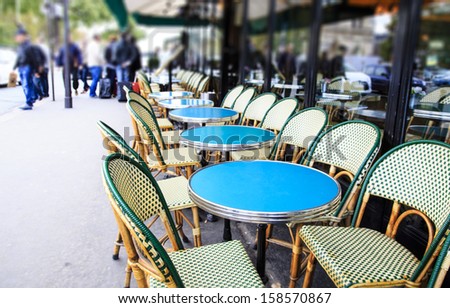 Classical Parisian open sidewalk cafÃ?Â© with it\'s rattan chairs and circular tables near Notre-Dame cathedral, Paris, France. Those chairs are very French-y, you see them all over the city