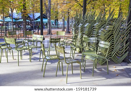 Classic green iron outdoor chairs of the Luxembourg garden piled in one of the garden\'s pavilions, Paris, France