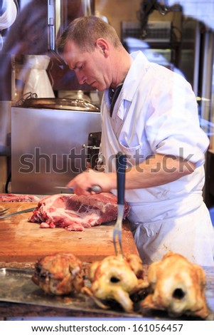 PARIS, FRANCE - OCTOBER 19:  Side view of the butcher working in the butchery rue Monge on October 19th 2013 in Paris, France,
