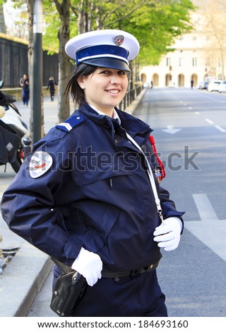 PARIS, FRANCE - MARCH 27 : Young French Policewoman smiling while posing in her uniform in front of the Luxembourg garden on March 27th, 2014 in Paris, France