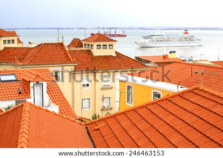 Lisbon - romantic view at red roofs and Tage river with boats, Portugal