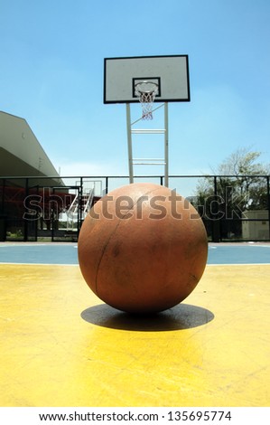 Basketball in outdoor basketball court on blue sky with daylight