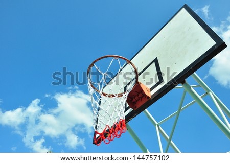Wooden basket hoop on blue sky.