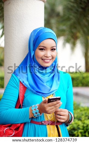 pretty hijab woman with handphone