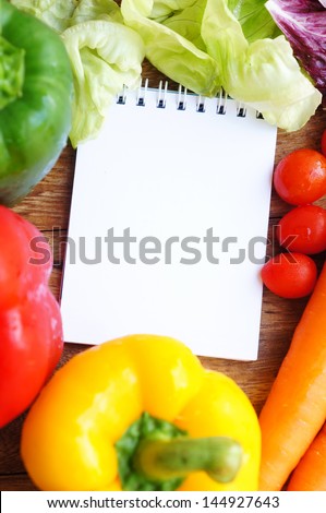 Open notebook ready for writing recipe with food ingredients
