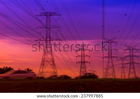 Beautiful sunset view of high-voltage tower and vehicle on fast motion