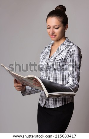 Smiling girl read journal in interior