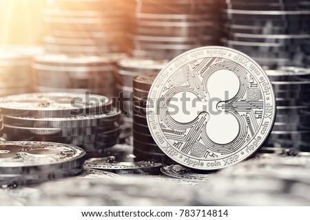 Silver Ripple coin among stack and piles of silver coins. Copy space on the left. 3D rendering