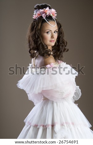 Fashion model posing in evening gown at retro style