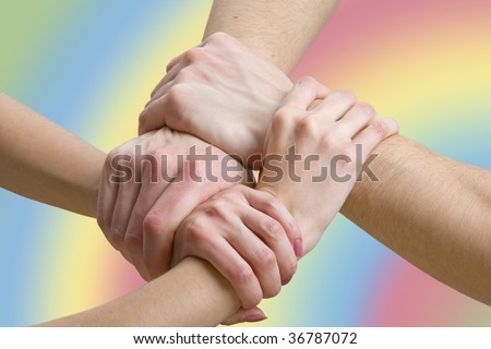 four hands touching each other, close-up
