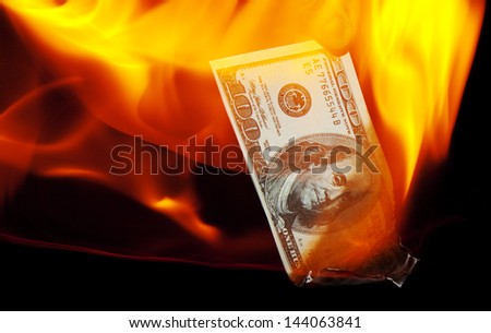 A hundred dollar bill on fire.