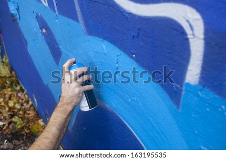 Hand Holding a Spray Paint Can