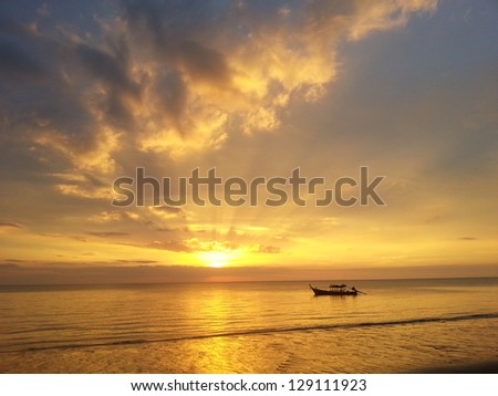 Magic sunset in thailand with a small fishing boat