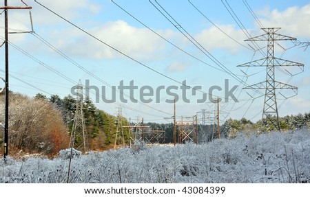 High power lines run through snow covered fields