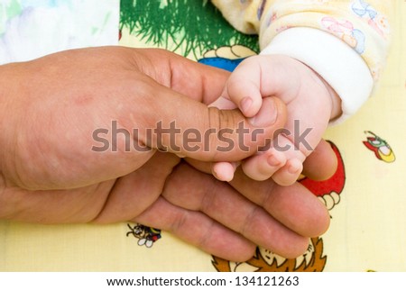 The child holds by the hand the father