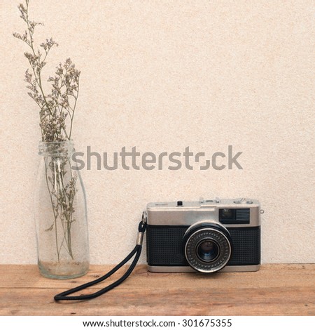 Vintage camera on wooden table,vintage effect filter style pictures