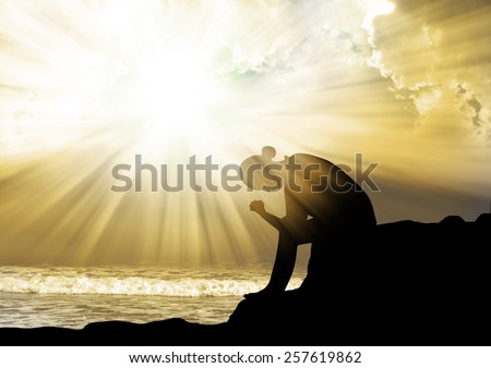 Woman praying to god  at sunset