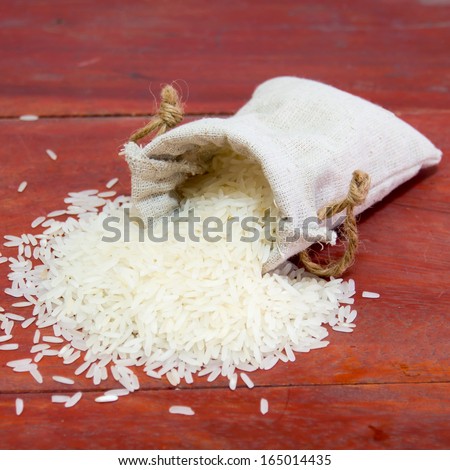 small bag of rice on a wood background