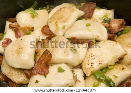 Wrapped potato with bacon and green onions with selective focus on the foreground