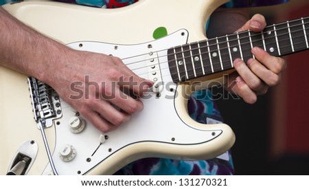 Closeup of a electric guitar and musician picks out some slick riffs