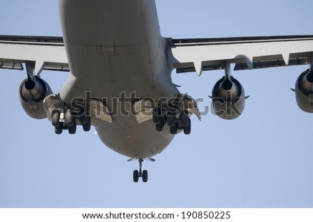 Closeup of the bottom are of a large transport plane landing