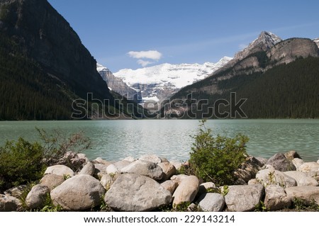 Selective focus on the boulders in the foreground with the lake and the mountains in the background at Lake Louise, Alberta, Canada