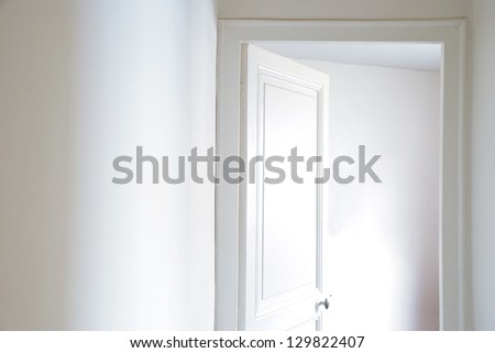 White door in white empty apartment
