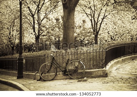 Old bicycle leaning against a fence in Montmartre (Paris, France)