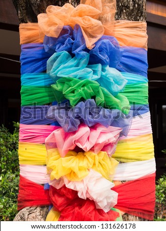 Multi-colored cloth wrapped around holy tree