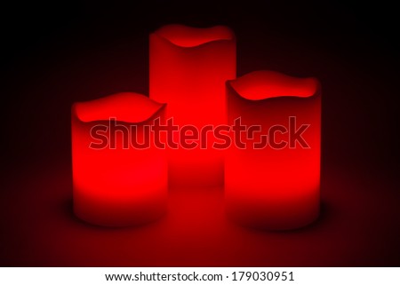 Three red LED candles in the dark