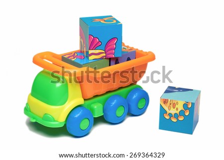 Colorful toy truck carrying bricks