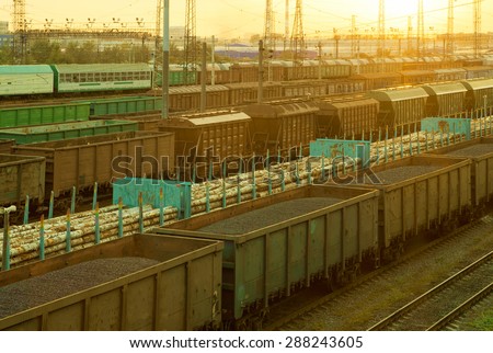 Railway cargo cars carrying coal and logs