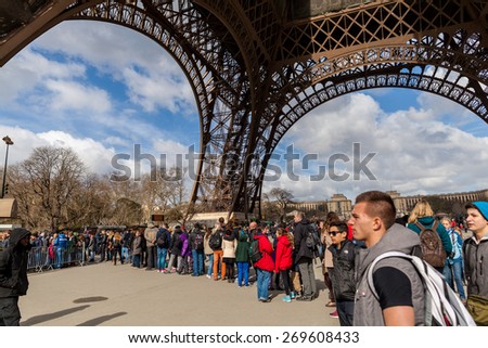 PARIS, FRANCE - APRIL 1, 2015: People Waiting in Long Queue at Eiffel Tower on April 1, 2015 in Paris France