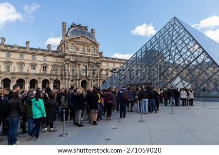 PARIS, FRANCE - APRIL 1, 2015: People Waiting in Long Queue at Louvre Museum on April 1, 2015 in Paris France