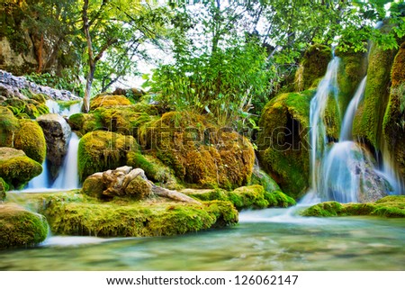 Summer view of beautiful small waterfalls in Plitvice Lakes National Park, Croatia
