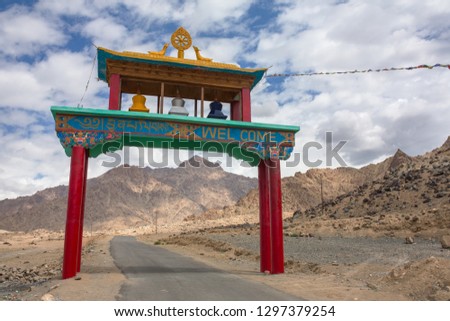 Arch entrance to the buddhist monastery with a Welcome sign in nepali and english on it in Ladakh refion in India.