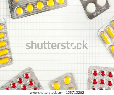 Packs of pills on checked notebook paper